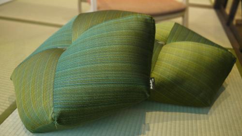 a green bag sitting on top of a floor at Machiya Kaemon in Kyoto
