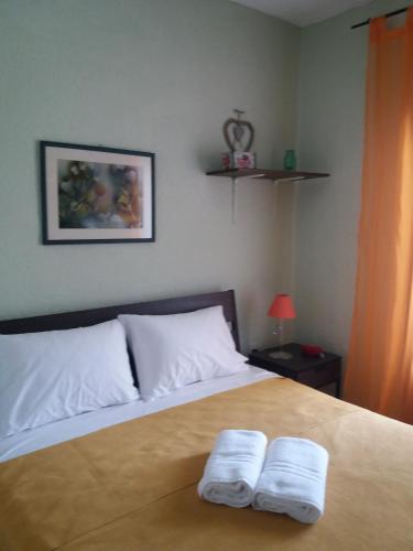 a bedroom with a bed with two towels on it at Siviri family house Oikismos Akri - Koroni in Siviri