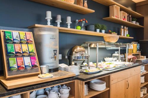 a kitchen with a counter with plates and dishes at Das Alfred in Sankt Pölten