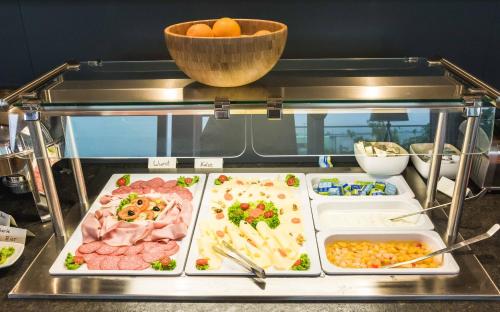 a buffet with different types of food on display at Das Alfred in Sankt Pölten