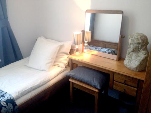a bedroom with a bed and a mirror on a desk at Rezydencja Solei Old Town in Poznań
