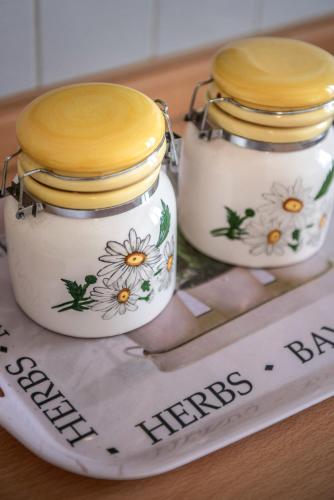 two jars with flowers on them sitting on a newspaper at Residence Daniele in Bellaria-Igea Marina