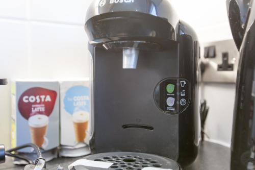 a coffee maker sitting on top of a counter at Leys Park Executive Apartments in Dunfermline