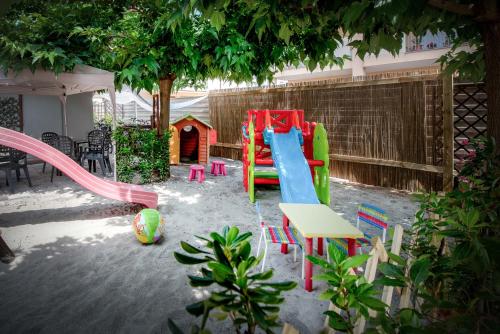 a playground with a slide and a play house at Residence Daniele in Bellaria-Igea Marina
