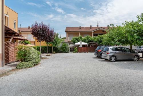two cars parked in a driveway in front of a house at Residence Daniele in Bellaria-Igea Marina