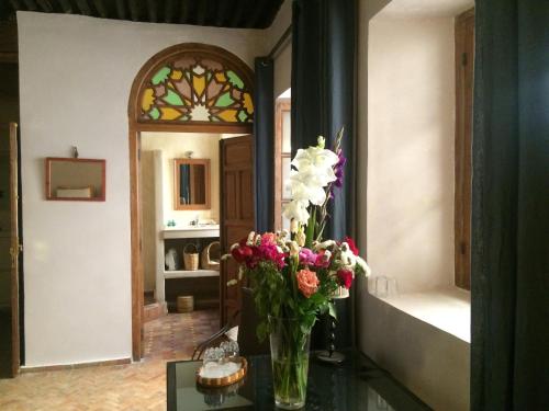 a vase of flowers sitting on a table in a room at Riad Marhaba in Rabat