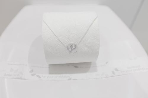 a white necklace with a flower on it on a box at Leys Park Executive Apartments in Dunfermline