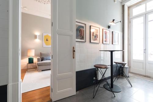a room with a hallway with a table and a living room at LovelyStay - Flower Stylish Apartment in Porto