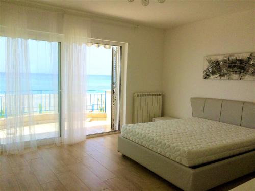 a bedroom with a bed and a view of the ocean at Villa sul Mare in Belvedere Marittimo