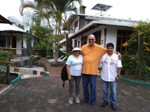 a man and two people standing in front of a house at Suymar Ecolodge Galapagos in Puerto Ayora