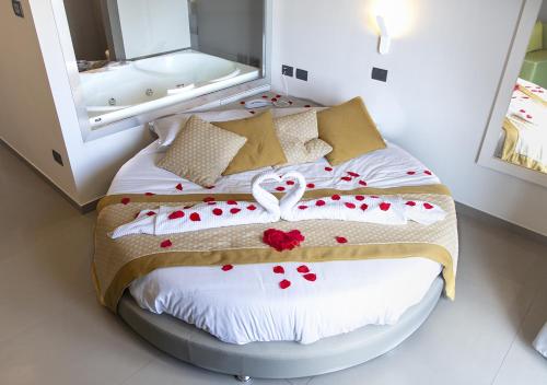 a bedroom with a bed with roses on it at Hotel Miramare in Marina di Varcaturo