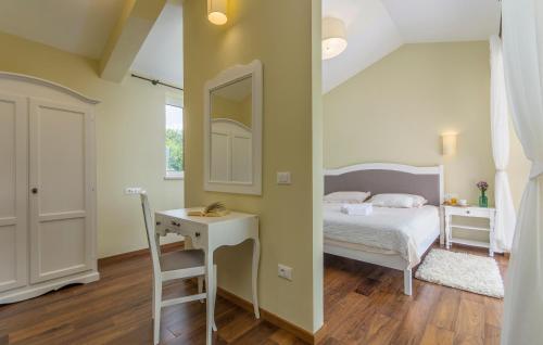 a bedroom with a bed and a desk and a mirror at Villa Sterpazzi - near Porec with Sea View, private Jacuzzi, Sauna and Pool in Višnjan