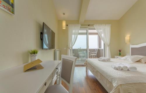 a bedroom with two beds and a desk and a window at Villa Sterpazzi - near Porec with Sea View, private Jacuzzi, Sauna and Pool in Višnjan