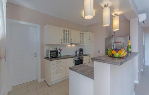 a kitchen with a counter with a bowl of fruit on it at Villa Sterpazzi - near Porec with Sea View, private Jacuzzi, Sauna and Pool in Višnjan