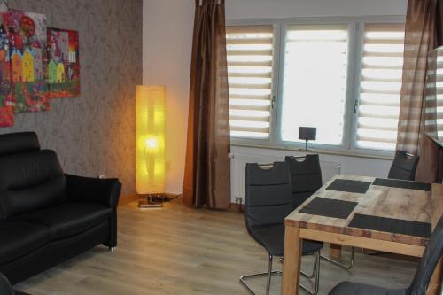 a living room with a dining room table and a couch at Wohnung in Datteln in Datteln