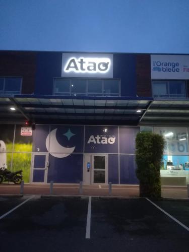 an atac store front with a sign on it at Atao Residence- Rennes Sud in Vern-sur-Seiche