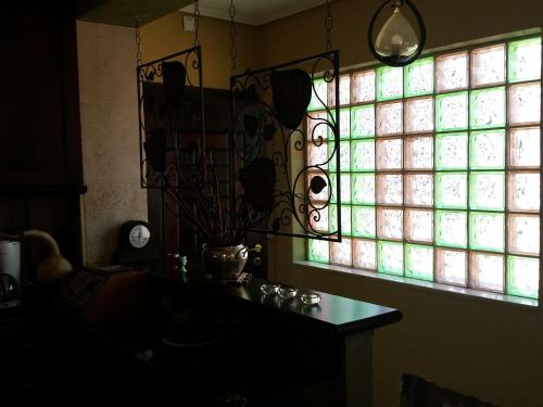 a window in a room with a table and a clock at DOWN TOWN LUXURY Apartment in Sarandë