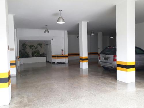 a parking garage with two cars parked in it at Hotel Sempre Executive in Salvador