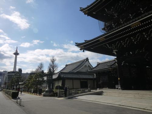 a large building with a tower in the background at Machiya Kaemon in Kyoto