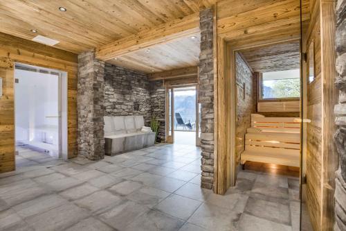 a bathroom with a stone wall and a tub at Hotel Burtschahof in Bürserberg