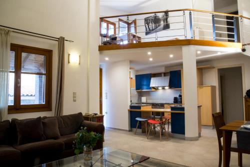 a living room with a couch and a kitchen at Maisonette House Minos in Heraklio