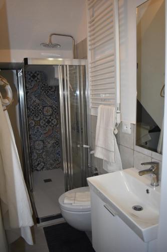 a bathroom with a shower and a toilet and a sink at Sea view Cornelia in Corniglia