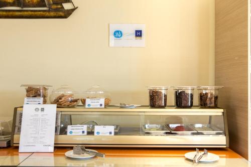 a display case in a bakery with some food at Aeolian Gaea Hotel in Skala Kallonis