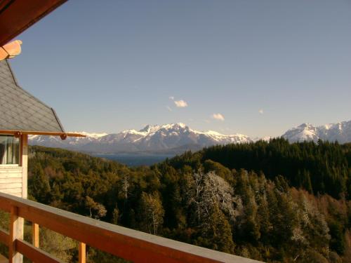a view of snow capped mountains from a porch at Hostería Isla Victoria Lodge in Isla Victoria