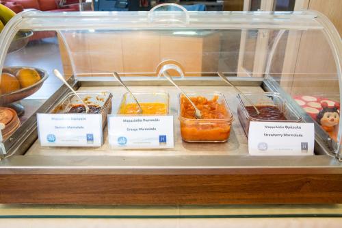 a display case with several different types of food at Aeolian Gaea Hotel in Skala Kallonis