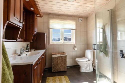 a bathroom with a sink and a toilet and a window at Valley View in Stranda