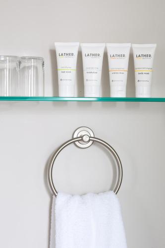 a towel rack with four bottles of white detergent at Gilded in Newport