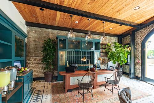 a kitchen with blue cabinets and a wooden ceiling at Andrew Pinckney Inn in Charleston