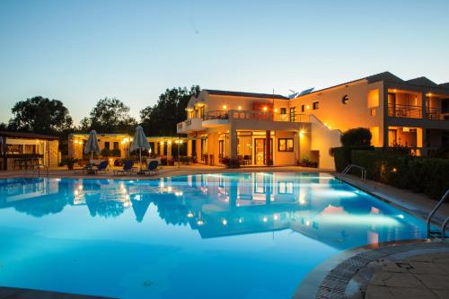 a large swimming pool in front of a house at Aeolian Gaea Hotel in Skala Kallonis