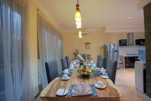 a dining room table with chairs and a long wooden table at O Villas Seminyak - 2026 Earlybirds ON SALE! in Seminyak