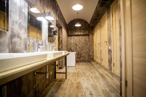 a bathroom with two sinks and wooden walls at ALL MUSIC Hostel #1 Mayakovskaya in Moscow