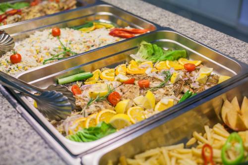 two trays of food on a counter at Hotel Sato Conference & SPA Resort in Sutomore