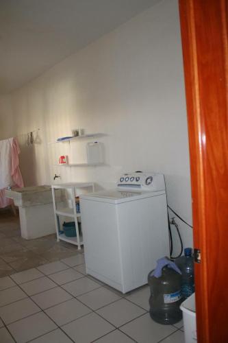 a small kitchen with a stove and a counter at Melaque Paradise in San Patricio Melaque