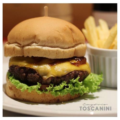 a cheeseburger on a plate with french fries at eSuites Savassi Toscanini in Belo Horizonte