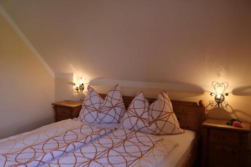a bedroom with a bed with two lights on it at am Jaukhof Familie Stiendl in Neudorf im Sausal