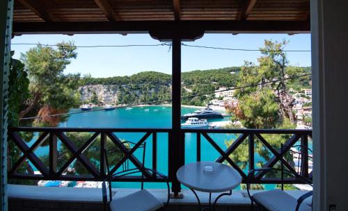 a view from the balcony of a resort with a boat in the water at Liadromia Hotel in Patitiri