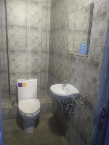 a bathroom with a toilet and a sink at Graffiti Mega City in Kyiv