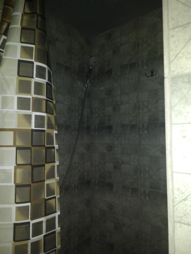 a shower in a bathroom with tiles on the wall at Graffiti Mega City in Kyiv