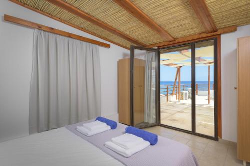 a bedroom with a bed and a view of the ocean at Haraki Sea View Luxury House in Rhodes Town