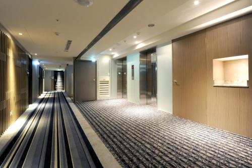 an empty hallway of a building with a bowling alley at International Citizen Hotel in Kaohsiung