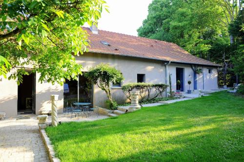 a small white house with a grass yard at Le Parc Stanislas in Chartres
