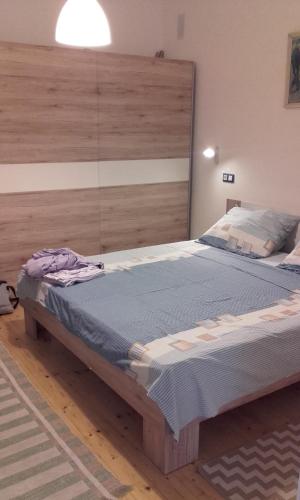 a bedroom with a large bed with a large headboard at Apartman Pašman K.B.168 in Pašman