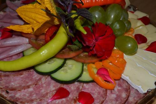 a plate of food with vegetables and a flower on it at am Jaukhof Familie Stiendl in Neudorf im Sausal