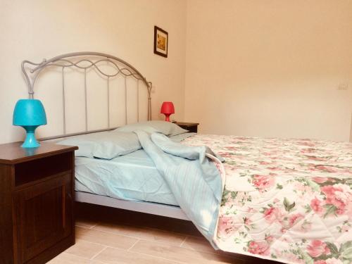 a bedroom with a bed and a lamp on a table at CasaLella in Viareggio