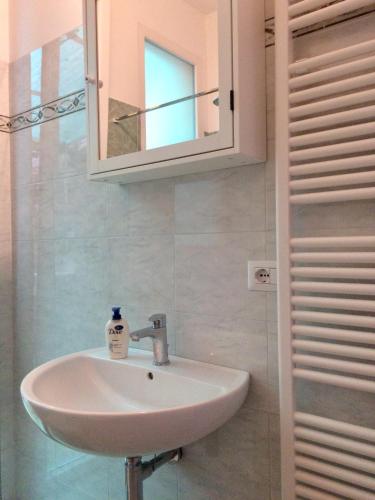 a bathroom with a sink and a mirror at CasaLella in Viareggio