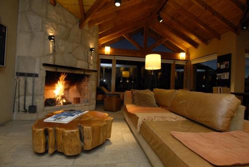 a living room with a couch and a fireplace at Galileo Boutique Hotel in San Carlos de Bariloche